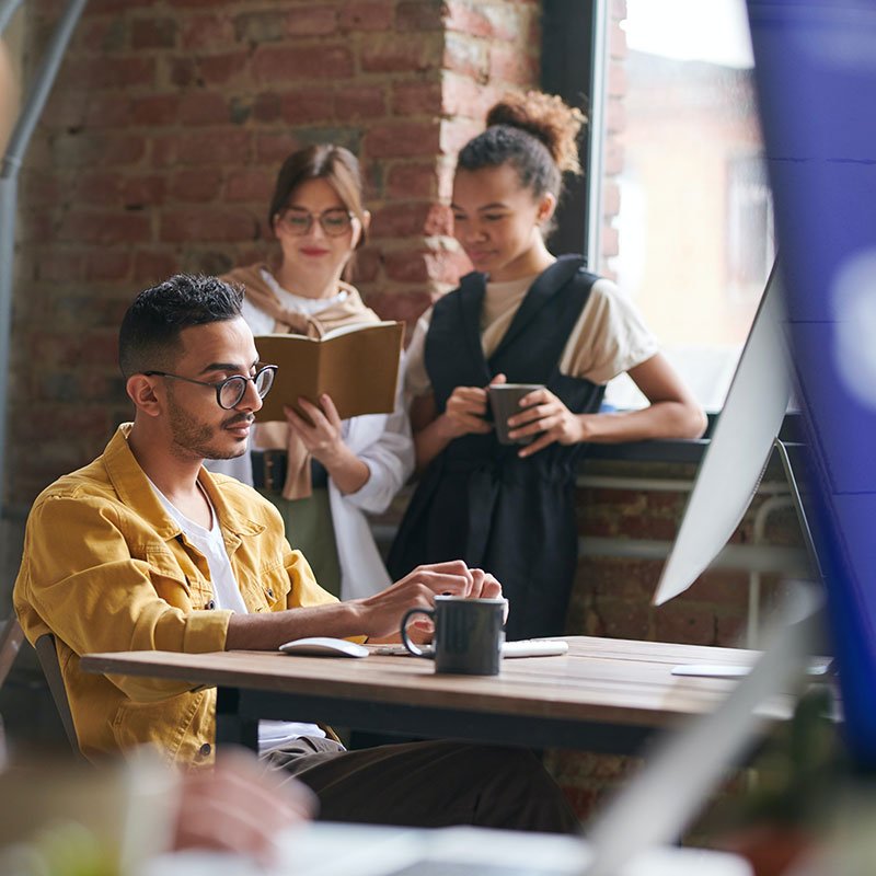 Small team collaborating in a casual workspace, representing SEO support for small businesses and nonprofits