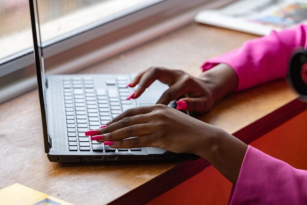 Close-up of person typing on laptop, symbolizing hands-on SEO support for small businesses and nonprofits